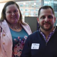 Two alumni enjoying their drinking while smiling for a photo
